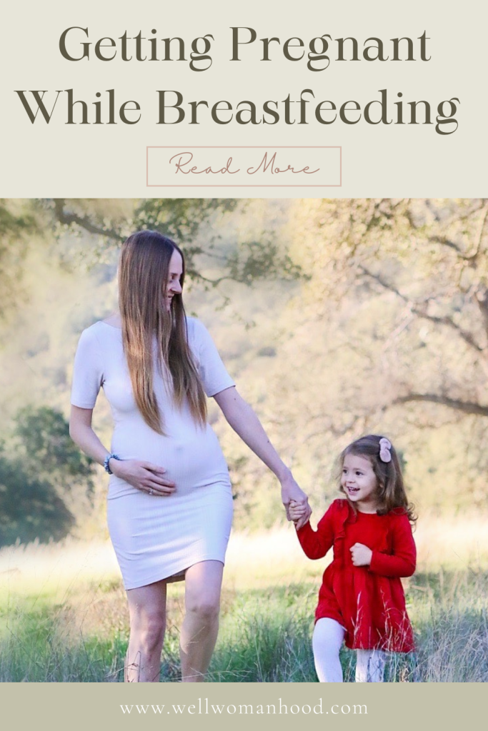 pregnant woman holding hands with daughter as they walk in the field