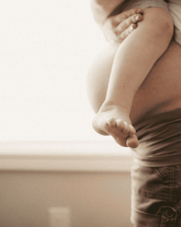 Pregnant woman holding her toddler